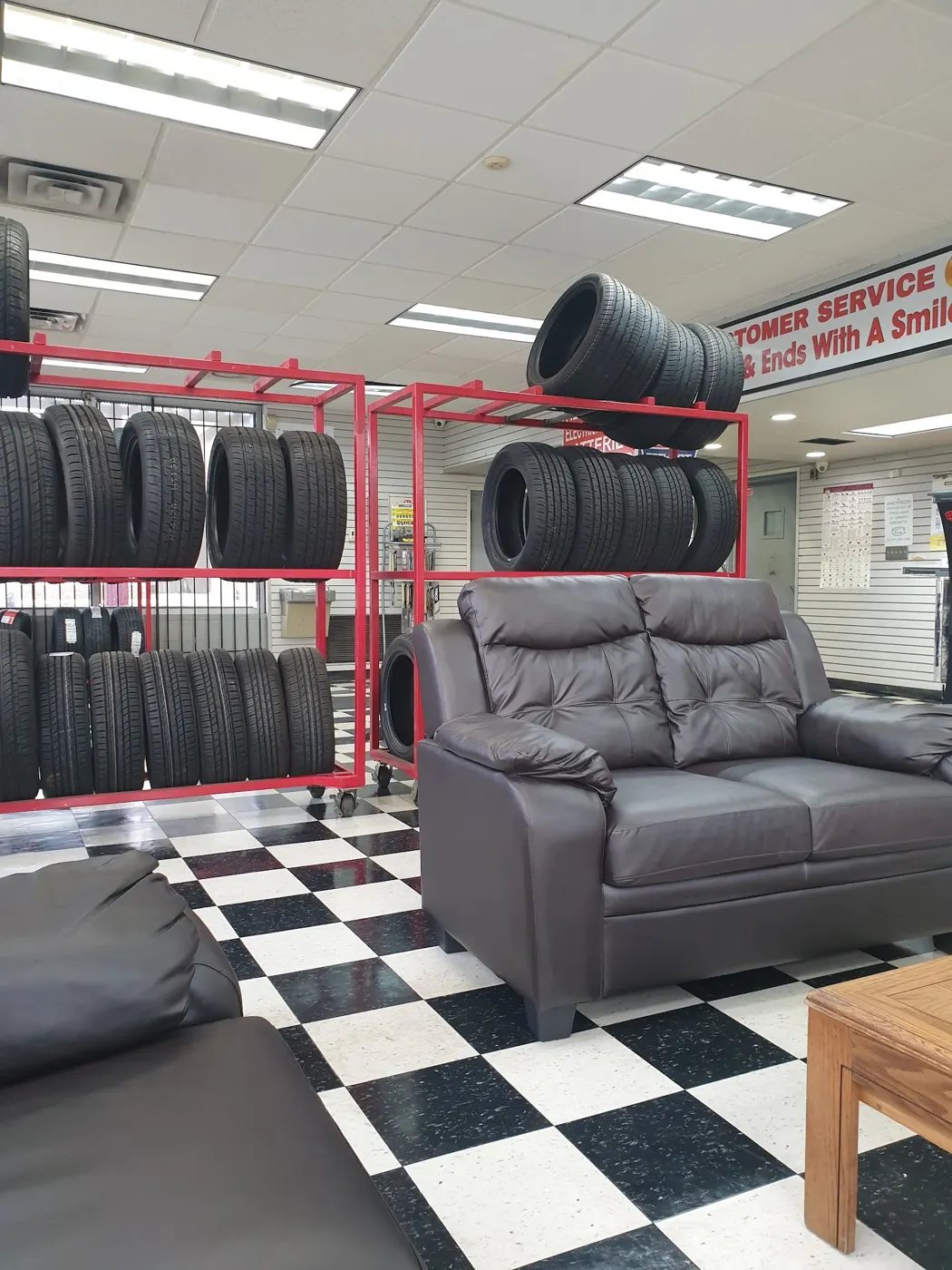The front counter inside Save On Tire, with the shop's service list on the wall