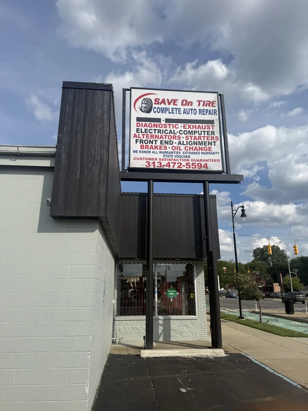 Save On Tire's sign listing diagnostic, exhaust, electrical, alternators, starters, front end, alignment, brakes and oil change